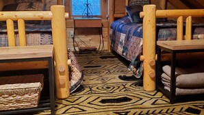 A cozy attic bedroom with two wooden beds, a desk with a lamp, and a window with a view. - Peaceful, secluded mountain escape in Gap Mills, WV. (Gap Mills)