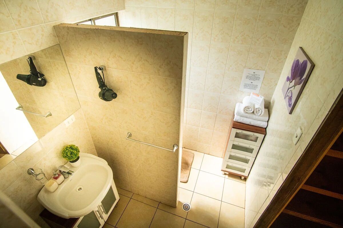 A bathroom with a shower, sink, and toilet.