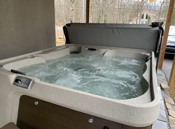 A hot tub with a control panel and a view of the outdoors.