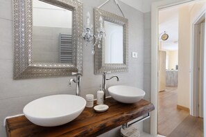 A bathroom with two large white sinks, a wooden vanity, and ornate mirrors. - Apartment 'Amazing View' with Private Terrace, Wi-Fi and Air Conditioning (Tellaro)