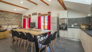 A modern kitchen with a built-in oven, microwave, and a kettle on the countertop. - Gîte Les Mélèzes – Mountain Views, Balcony & Wi-Fi (TERMIGNON)