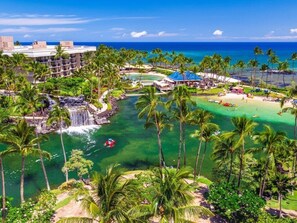 Escape to a tropical paradise surrounded by a serene body of water and lush palm trees.