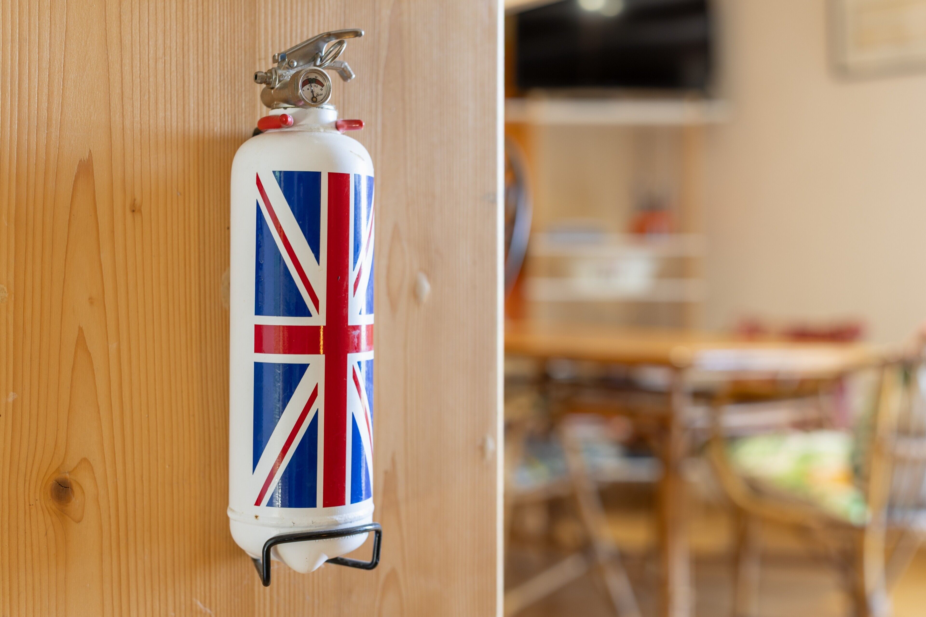 A fire extinguisher mounted on a wooden door.