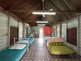 Un dormitorio con literas, ventilador de techo y suelo estampado.