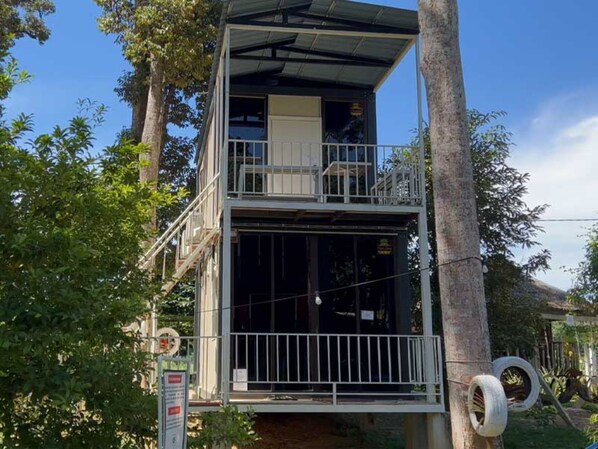 A two-story building with a balcony on the upper floor, surrounded by trees. - Resort D'Rumah Bonda River View (Kuala Kangsar)