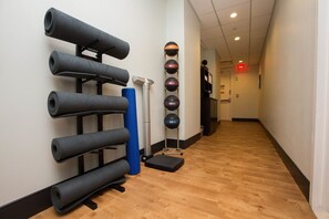 A hallway with yoga mats, a blue foam roller, and a medicine ball rack. - New York City | Elegant Manhattan Stay | Central Location | Studio Premier (New York)