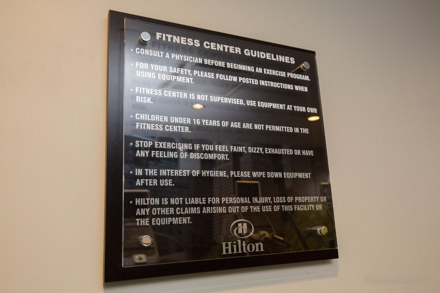 A sign with fitness center guidelines.