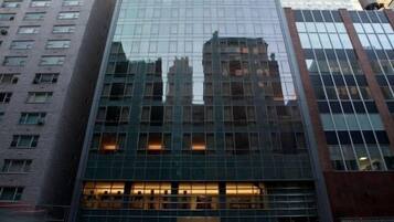 A high-rise building with a glass facade, multiple floors, and a modern architectural design.