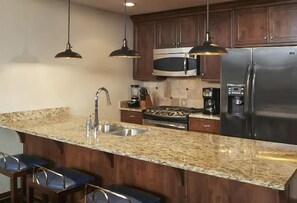Fridge, microwave, stovetop, coffee/tea maker
