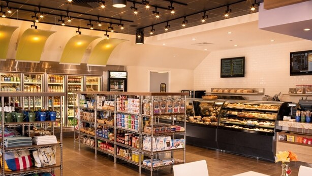 A bakery section with shelves of baked goods and a display case of pastries. - Orlando | Elevated Disney Retreat | Pool + Parks (Orlando)