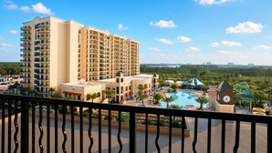 A hotel with multiple floors, a swimming pool, and a clock tower. - Orlando | Upscale Disney Retreat | Pool + Parks (Orlando)