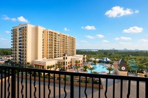 A hotel with multiple floors, a swimming pool, and a clock tower. - Orlando | Romantic Disney Retreat | Pool + Parks (Orlando)