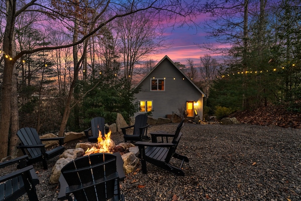 Lounge by the firepit under string lights and a sky of shimmering stars.