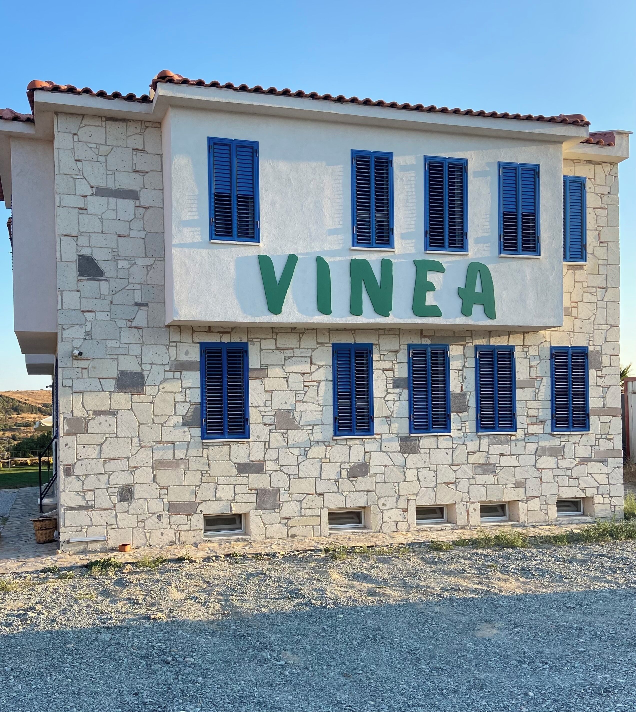 A building with the name "VINEA" in large green letters on the facade.