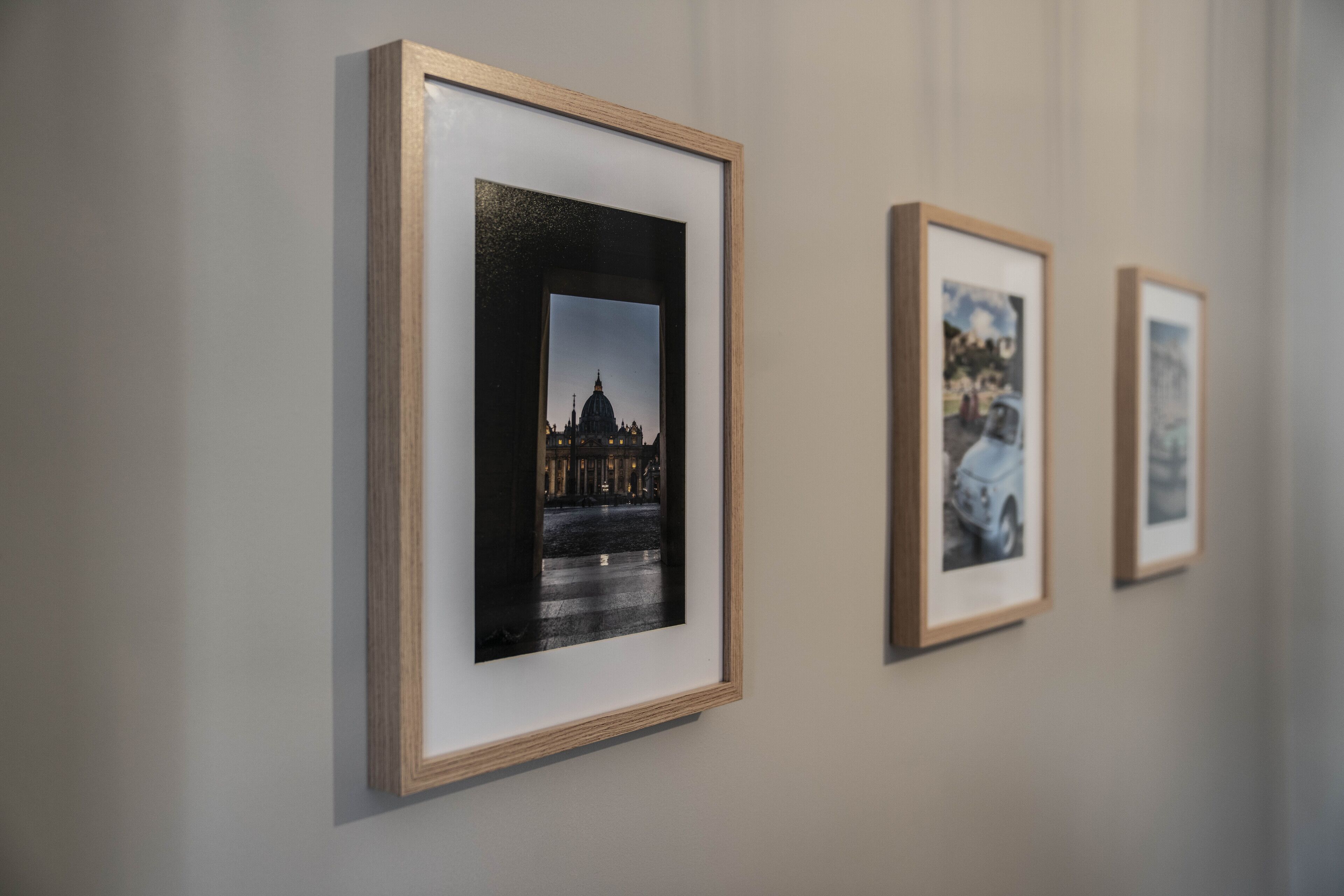 A series of framed photographs on a wall.