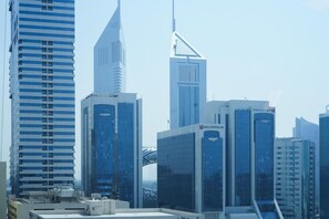 A cityscape with modern high-rise buildings, including a prominent skyscraper with a pointed top. - Shada Hotel Dubai (Dubai)