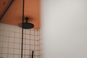 A shower with a black handheld showerhead and a vertical bar. - Shada Hotel Dubai (Dubai)