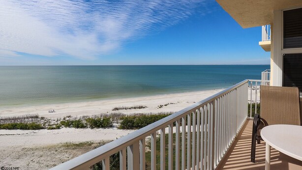 A balcony with a view of a beach and ocean. - Beachfront EBTC 804A w/ Million $ View! Bargain Price! Pool! Tennis! (Fort Myers Beach)