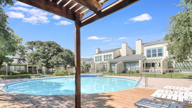 A wooden deck with a pool and lounge chairs. - Adventure House Rryc17 2 Bedroom Condo by RedAwning (Rockport)