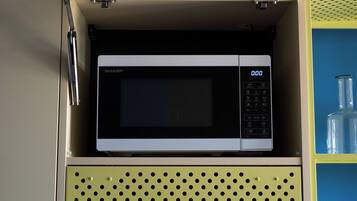 A microwave in a cabinet with a digital display.