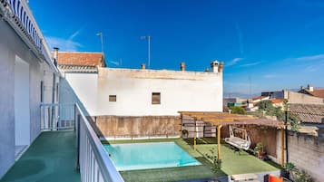 Enjoy a rooftop retreat with a swimming pool, garden, and pergola.