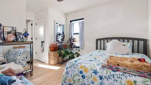 A bedroom with a bed, a desk, and a window. - Pet-Friendly Carriage House Close to Downtown (Indianapolis)