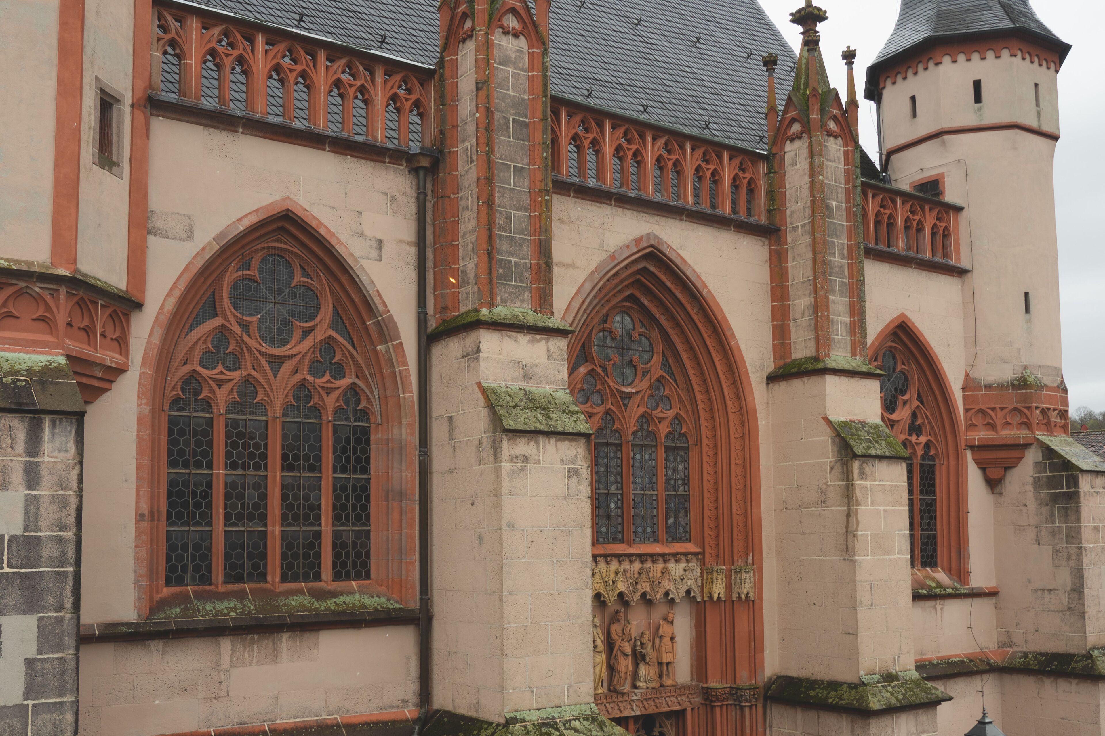 A historic building with large arched windows and a tower.
