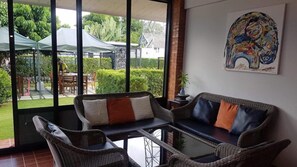 Grand Villa | Living area | 32-inch flat-screen TV with digital channels - Nomads Riverside Chiangmai (Chiang Mai)