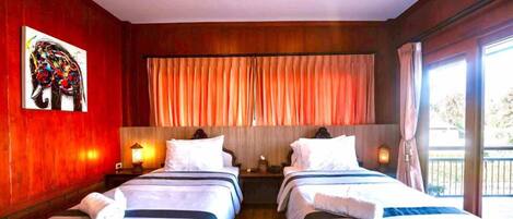 A hotel room with two beds, a large window with curtains, a painting on the wall, and a balcony.