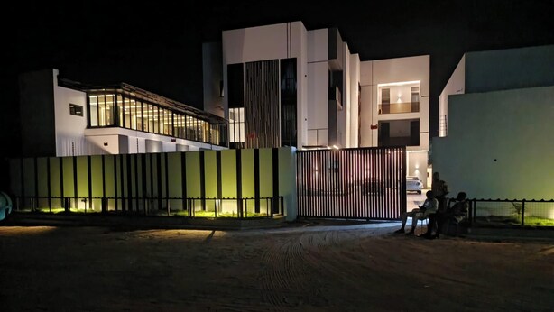 A modern building with a gated entrance at night. - Polo Grand Hotel (Maiduguri)