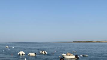 Enjoy serene waterfront views and moored boats in a secluded coastal setting.