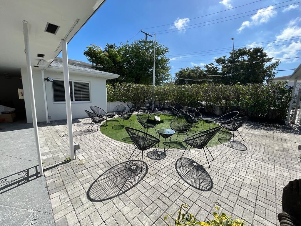 A patio area with outdoor seating and a small lawn.