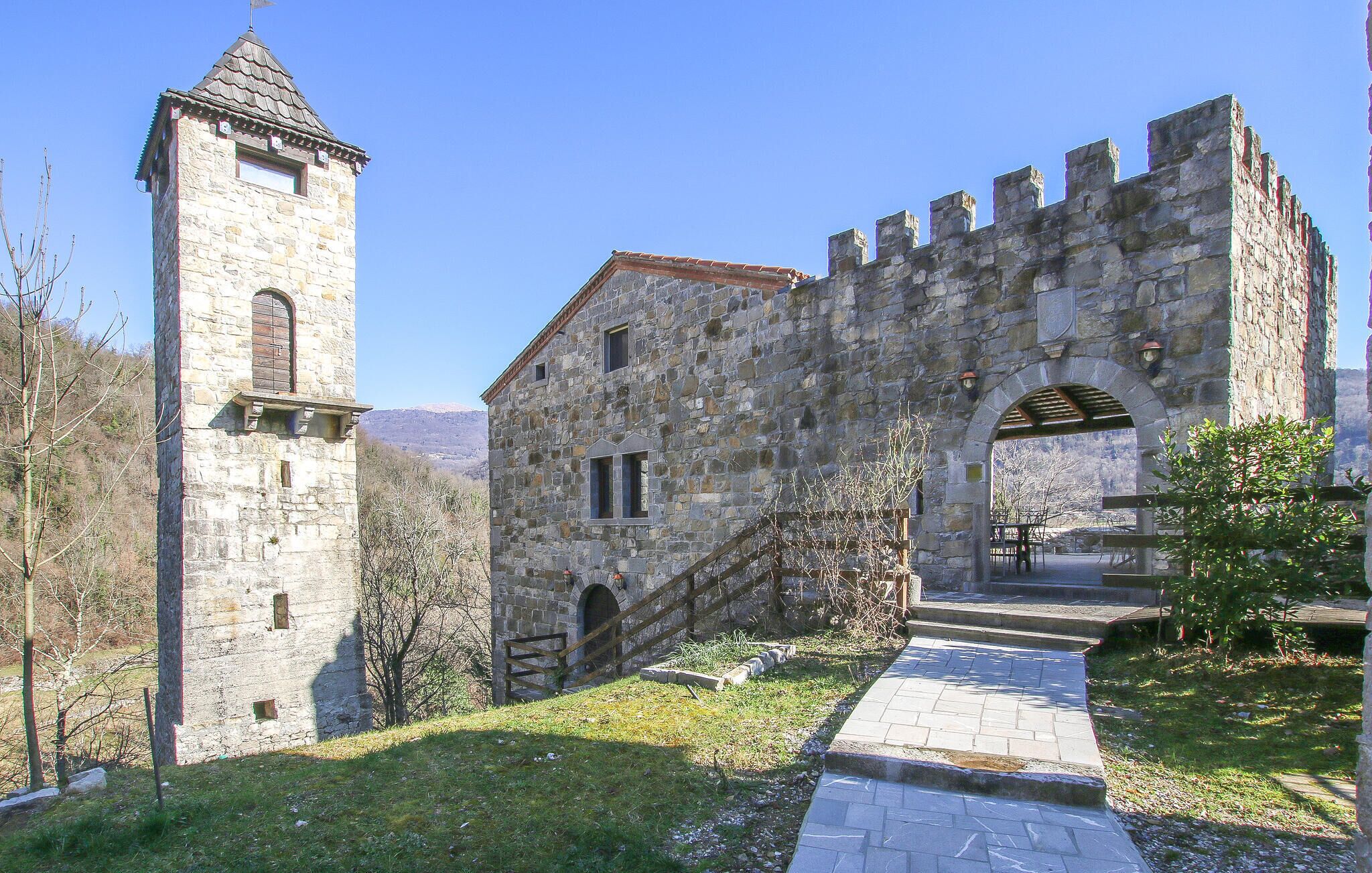 A historic stone building with a tower and arched entrance.