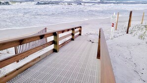 A wooden boardwalk leading to a sandy beach with a sign indicating 'Leave Only Trash'. - Direct Beachfront Condo in Gulf Shores/ 2 King Suites/ 2 Pools (Gulf Shores)