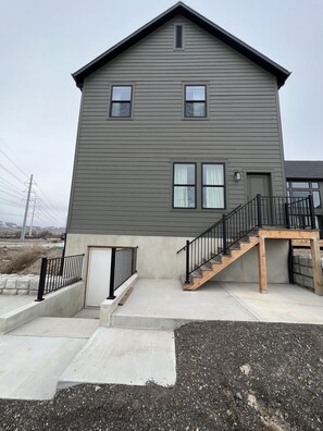 A two-story house with a front porch, a staircase, and a small front yard. - Little ranch in the city! (Lehi)
