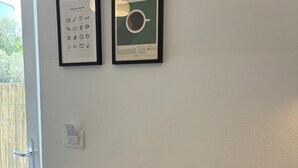 A kitchen with a black sink, a framed Italian pasta guide, and a framed espresso guide on the wall. - Villa Reise (Riomaggiore)