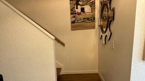 A staircase with wooden steps and a white wall.