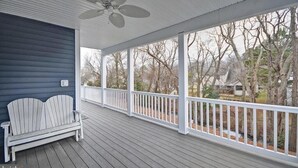 A covered porch with a ceiling fan, white railing, and a bench. - Dream getaway just 2 miles from Fenwick or OC beach.  5BR house sleeps up to 13 (Selbyville)