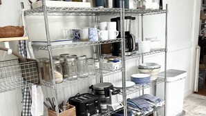 A kitchen with a metal shelving unit holding various kitchen items, a coffee maker, and a toaster. - Blue and White Hill House a home nestled on the east side of Saratoga Springs. (Saratoga Springs)