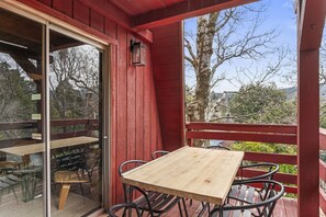Enjoy dining or meeting on the deck with a lantern-lit view of the surrounding trees and landscape.