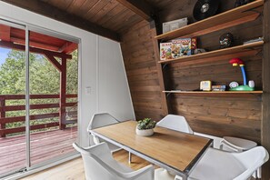Cozy retreat with a wooden table, potted plant, and comfortable seating area.