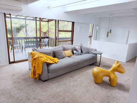 Living area. Cosy Stylish Glenfield Home: Bush Views, Serenity, and Modern Comfort