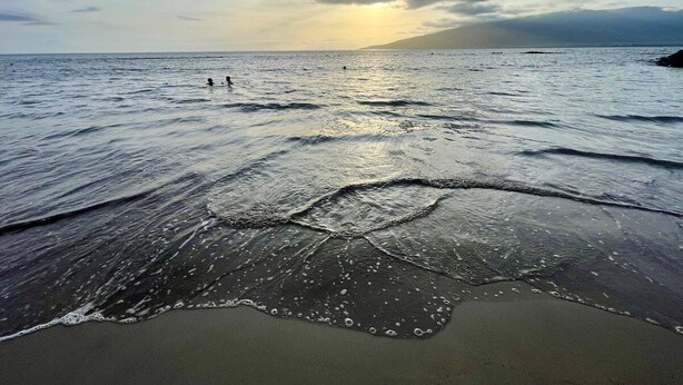 A beach with waves and a sunset in the background. - Perch - Maui condo: Pool, beach access, daily tranquility on lanai – an indulgent escape. (kihei)