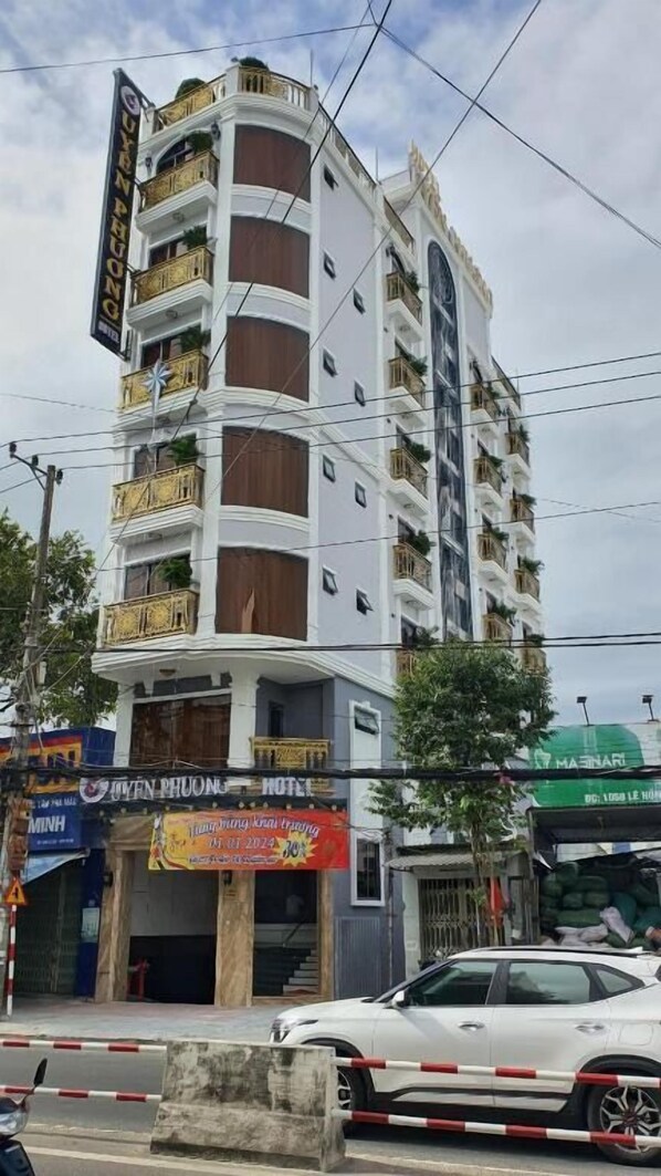 A multi-story hotel with balconies, a sign for 'JYTEN PHUONG HOTEL', and a banner advertising a 'Kingdom Karaoke Party' event. - Uyên Phương Hotel Nha Trang (Nha Trang)