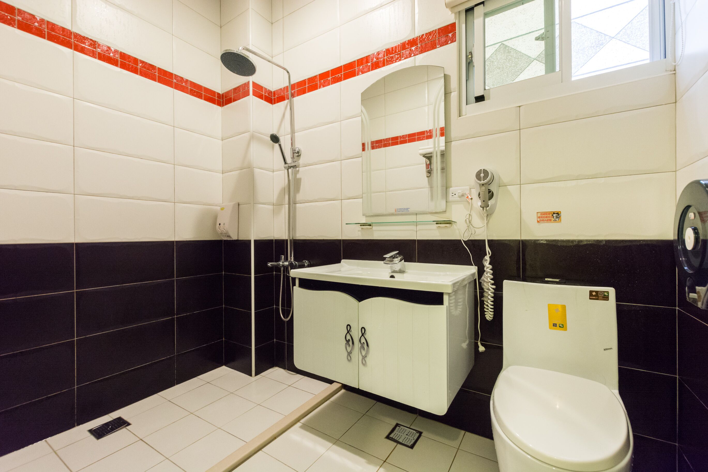 A bathroom with a shower, sink, and toilet.