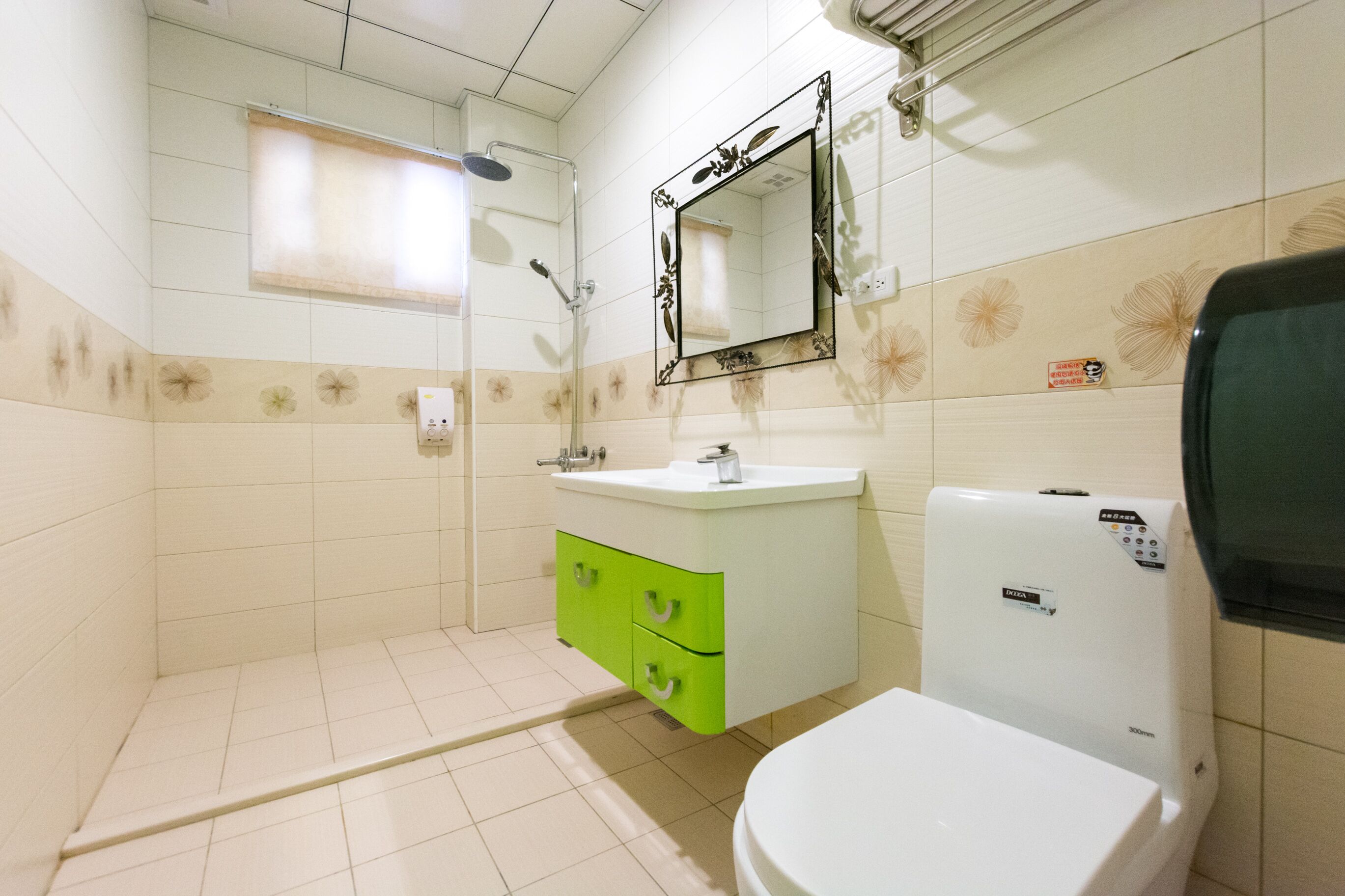 A bathroom with a toilet, sink, and shower.