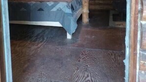 A log cabin room with a bunk bed, a wooden chair, and a small table. - cozy cabin (Copper Center)