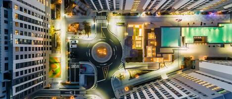A high-rise building with multiple floors, a roundabout, and a green-lit area.