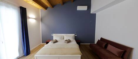 Deluxe Room, 1 King Bed with Sofa bed, City View | Premium bedding, down comforters, memory foam beds, desk