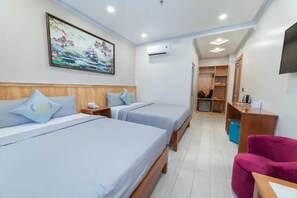 A hotel room with two beds, a wooden headboard, a painting on the wall, a desk, a chair, and a wardrobe. - Thao Nho Hotel Phu Quoc - by Bay Luxury (Phu Quoc)
